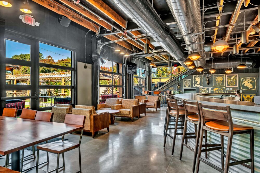 The Silos – 5 Unity coffee tables, 5 small walnut tables, 3 large walnut round tables, 1 large rectangle walnut table. Courtesy of Mantra Inspired Furniture.