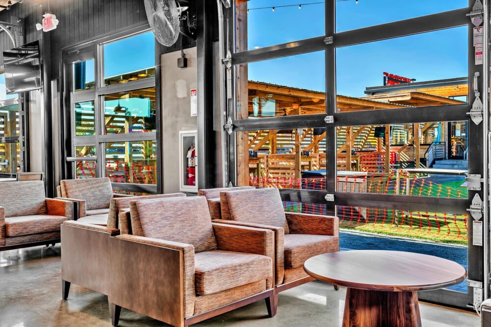 The Silos – 5 Unity coffee tables, 5 small walnut tables, 3 large walnut round tables, 1 large rectangle walnut table. Courtesy of Mantra Inspired Furniture.