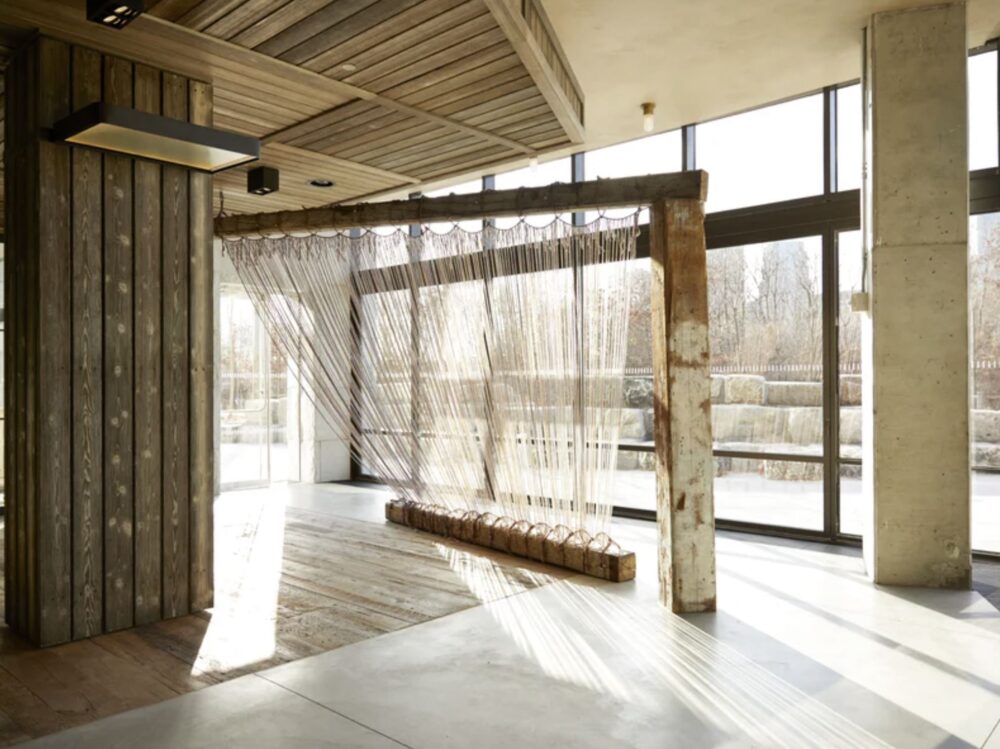 Over half of 1 Hotel Brooklyn Bridge is built from regional and reclaimed materials, including original heart pine beams from the former Domino Sugar Factory, now at home in tables and benches throughout the common spaces. Photo: James Baigrie.